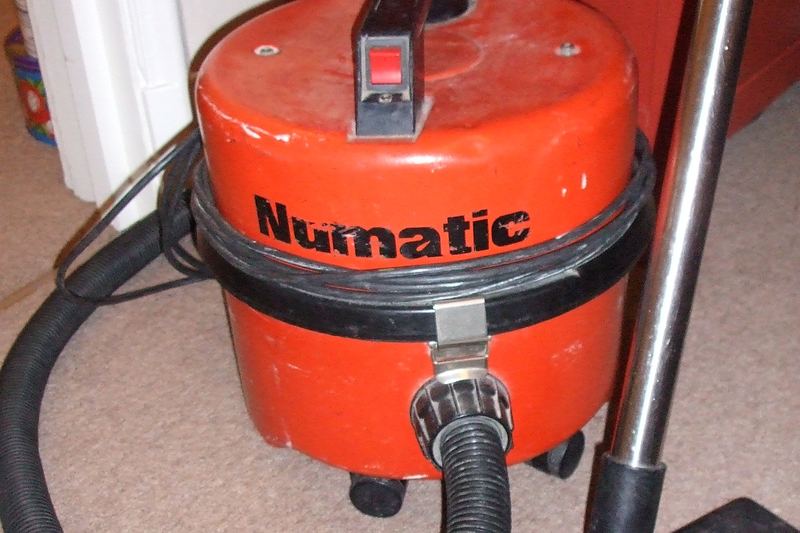 Person vacuuming a home floor